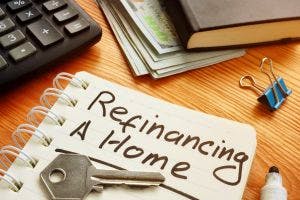a notepad with "refinancing a home" written on the page